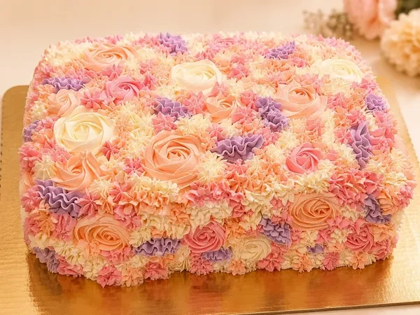 Pink and lavender Garden Collection cake covered in buttercream flowers