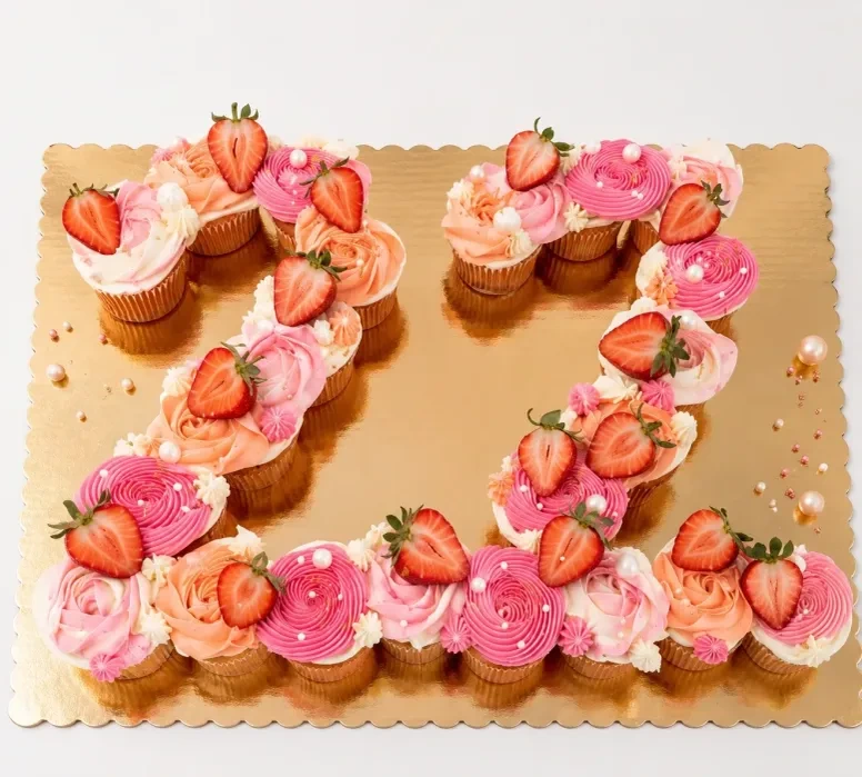 Number 72 pull-apart cupcake cake decorated with pink buttercream and fresh strawberries